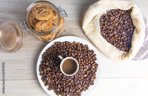Coffee beans on plate and in coffee bag with cookie jar
