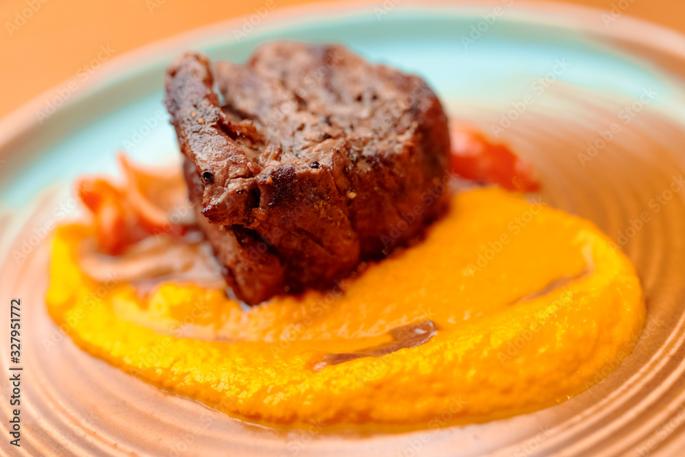 grilled steak with sauce and vegetables on white plate grilled steak with sauce and vegetables on white plate