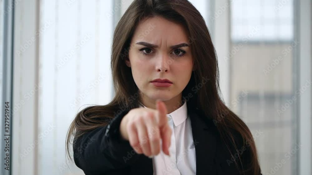 Business woman points straight to the camera, isolated on white panoramic background. Slow motion. Close up. Copy space. 4K. Business woman points straight to the camera, isolated on white panoramic background. Slow motion. Close up. Copy space. 4K.