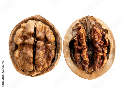 Two open walnuts in a shell , a good walnut and a spoiled walnut, isolate on a white background