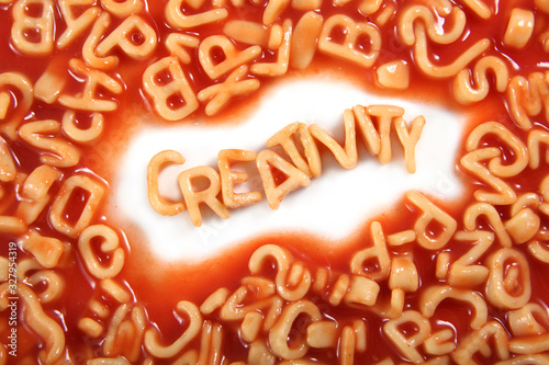 Creativity written in spaghetti pasta letters surrounded with jumbled letters. photo