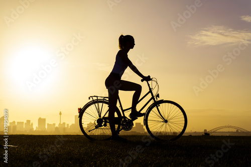 Cyclist girl at sunset, Sydney Australia