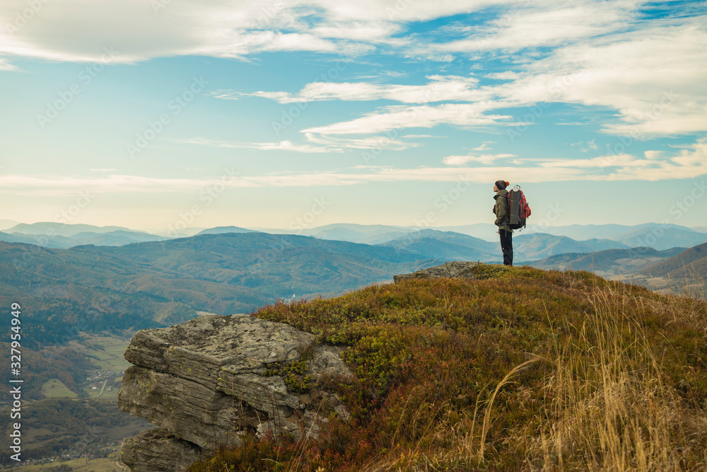 Obraz premium hiking mountain top edge of cliff highland scenic view with backpacker male person stay and looking side ways life style poster concept empty copy space for text