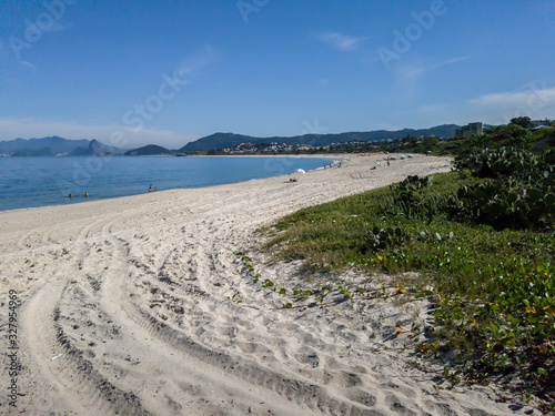 Camboinhas, Niteroi, Rio de Janeiro, Brazil, walking a trail with coconut trees, a different way to reach the beach, clear blue sea, clear sands and blue sky!