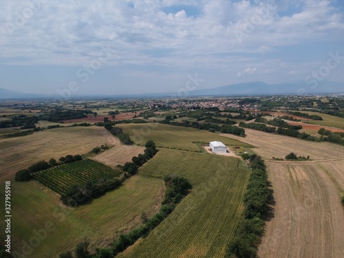 Aerial drone landscape photo from high above of fields in a clear weather summer day in the outskirts of Drama, Greece