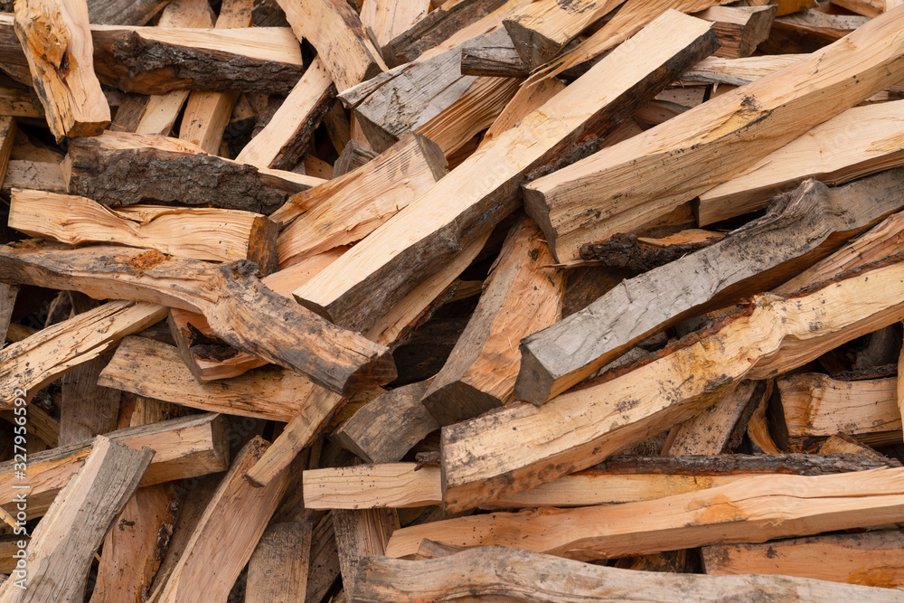 Wooden background. Firewood stack for the background. A lot of cutted logs. Stack of sawn logs. Natural wooden decor background. Pile of chopped fire wood prepared for winter. Wooden background. Firewood stack for the background. A lot of cutted logs. Stack of sawn logs. Natural wooden decor background. Pile of chopped fire wood prepared for winter.