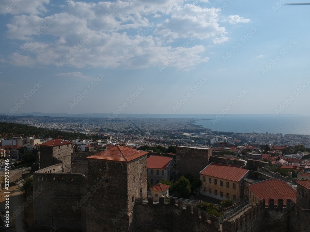 Aerial drone shot over the city of Thessaloniki revealing a medieval castle and the city in Sykies