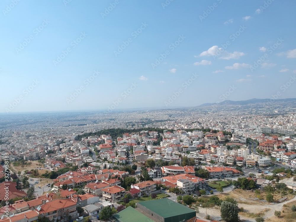 Aerial drone shot over the city of Thessaloniki revealing a medieval castle and the city in Sykies
