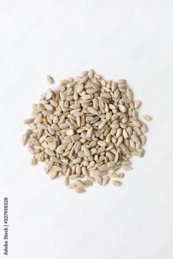 peeled sunflower seeds in a circle on a white background from above peeled sunflower seeds in a circle on a white background from above