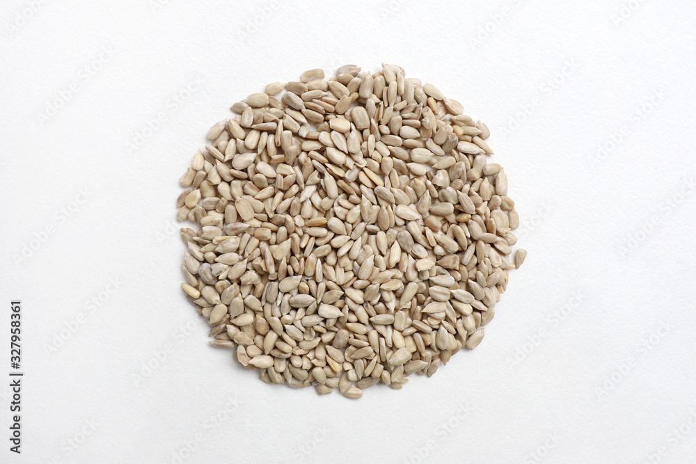 peeled sunflower seeds in circle on white background from above peeled sunflower seeds in circle on white background from above