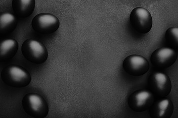 Black eggs on a black background. Easter minimalistic concept