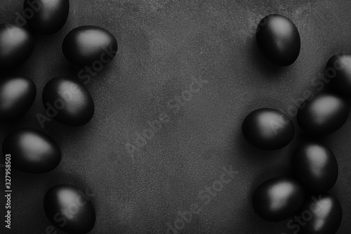Canvas Print Black eggs on a black background. Easter minimalistic concept