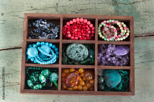 Beads from natural stones for making jewelry and souvenirs in the box.