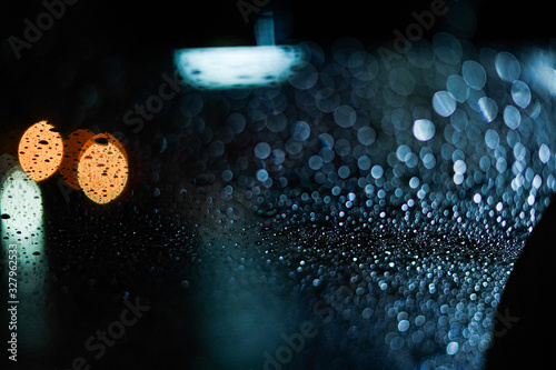 Bokeh of City Behind the Rainy Night Window Glass close-up