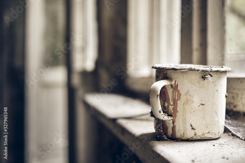 Rusted old metal cup in an old dusty room