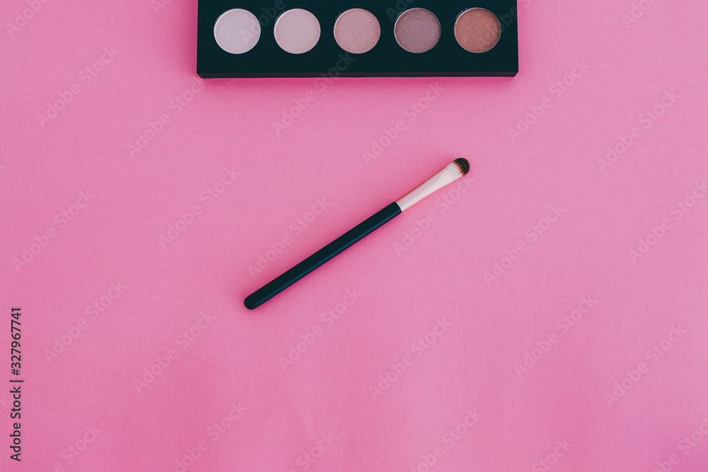 cosmetics products still-life, eyeshadow palette with brush on minimaist pink background and copyspace cosmetics products still-life, eyeshadow palette with brush on minimaist pink background and copyspace