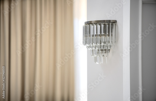 Fotografija Metallic colored sconce on wall