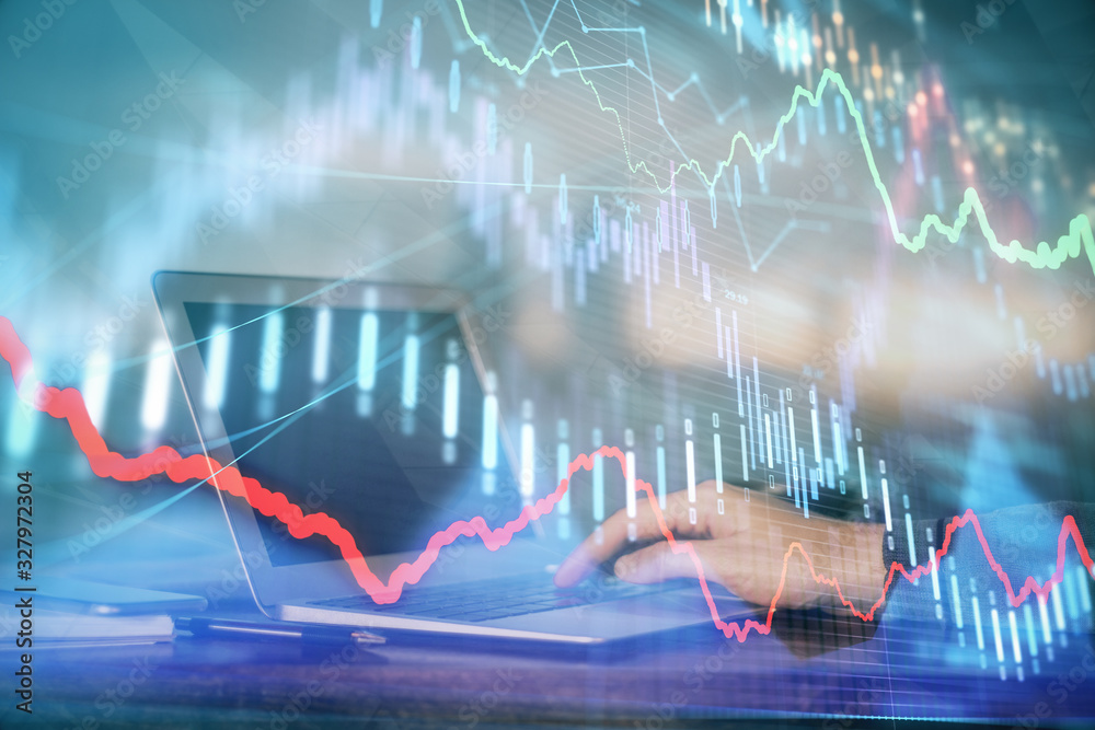 Double exposure of stock market graph with man working on laptop on background. Concept of financial analysis. Double exposure of stock market graph with man working on laptop on background. Concept of financial analysis.