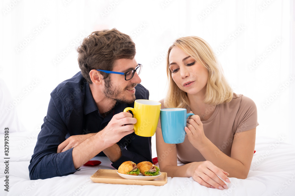 Lovely caucasian couple enjoy having a breakfast and black coffee together. Lovely caucasian couple enjoy having a breakfast and black coffee together.
