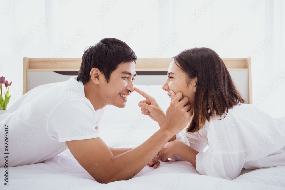 Intimacy asian husband and wife in romantic moment together on the bed in morning. Lovely husband and wife portrait with togetherness in valentines day concept.