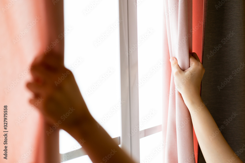 Fototapeta premium Happy Beautiful young Asian woman opening window curtain in the morning. 
