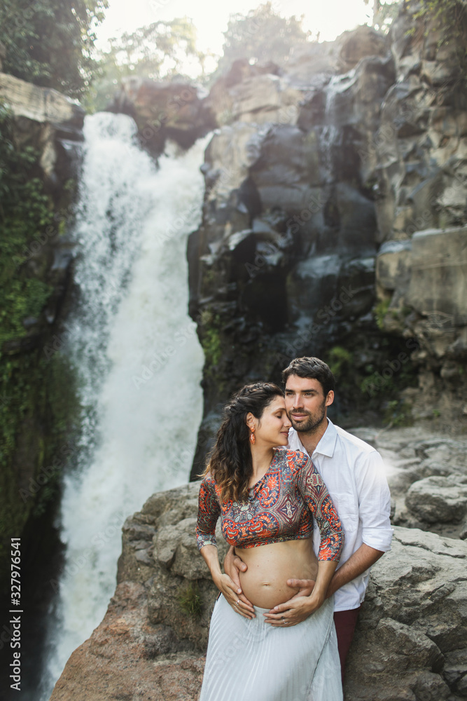 Portrait of young pregnant latin american couple in love outdoors. Family values. Happy together and smiling, pregnancy travel lifestyle. Naked belly. Portrait of young pregnant latin american couple in love outdoors. Family values. Happy together and smiling, pregnancy travel lifestyle. Naked belly.