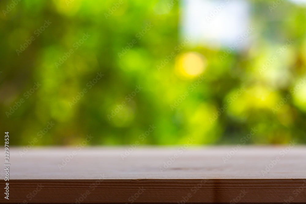 Empty wooden table texture, Green garden blurred bokeh background, Selective focus Empty wooden table texture, Green garden blurred bokeh background, Selective focus