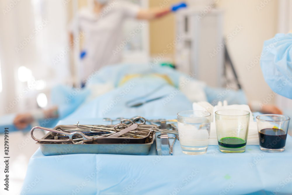 Hospital. Surgeon operates in the operating room. Close-up of surgical tools prepared for operation Hospital. Surgeon operates in the operating room. Close-up of surgical tools prepared for operation
