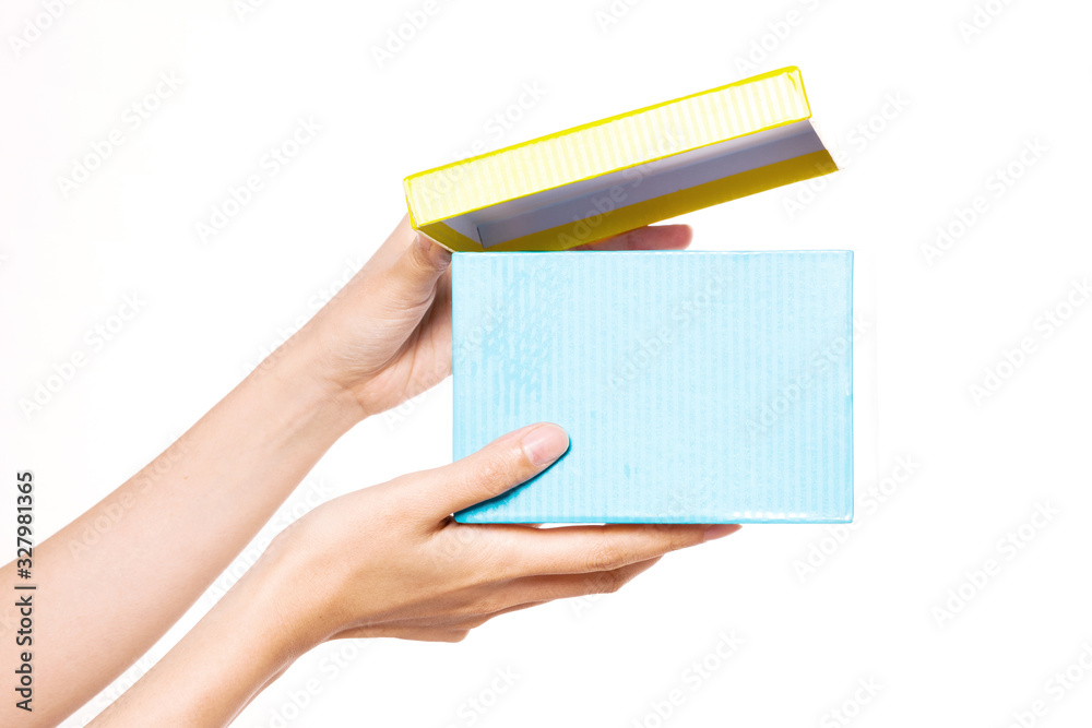 Woman hand hold a blue box isolated on white. Woman hand hold a blue box isolated on white.