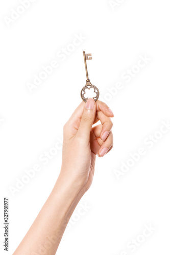 Woman hand hold a vintage key isolated on white.