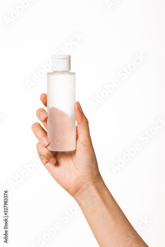 woman hand hold a cosmetic mock-up container isolated on white.