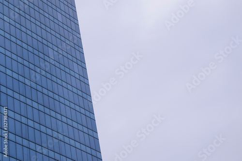 Glass building Many windows. Background sky. Concept of corporation office, skyscraper.