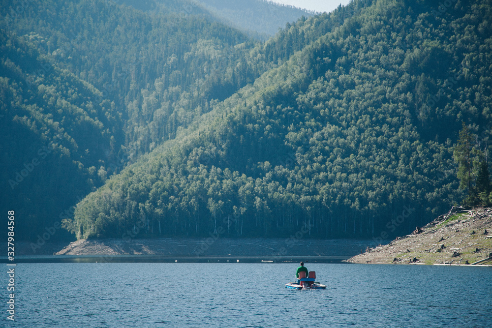the concept of boating, recreation, travel-a man rides a catamaran. Boating on the lake the concept of boating, recreation, travel-a man rides a catamaran. Boating on the lake