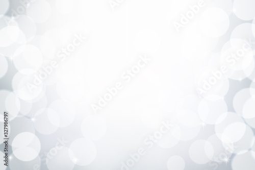 White and grey bokeh effect  Winter snowy background  Abstract blurred vector backdrop.