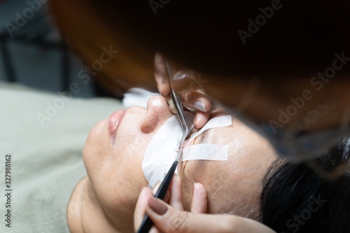 Procedure of eyelashes extension in salon. close up long eyelashes on Eyelash extension.