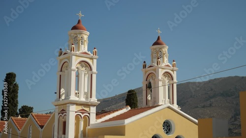 The two towers of Saint Eleutherius church in Ano Symi, Symi Island, Greece photo