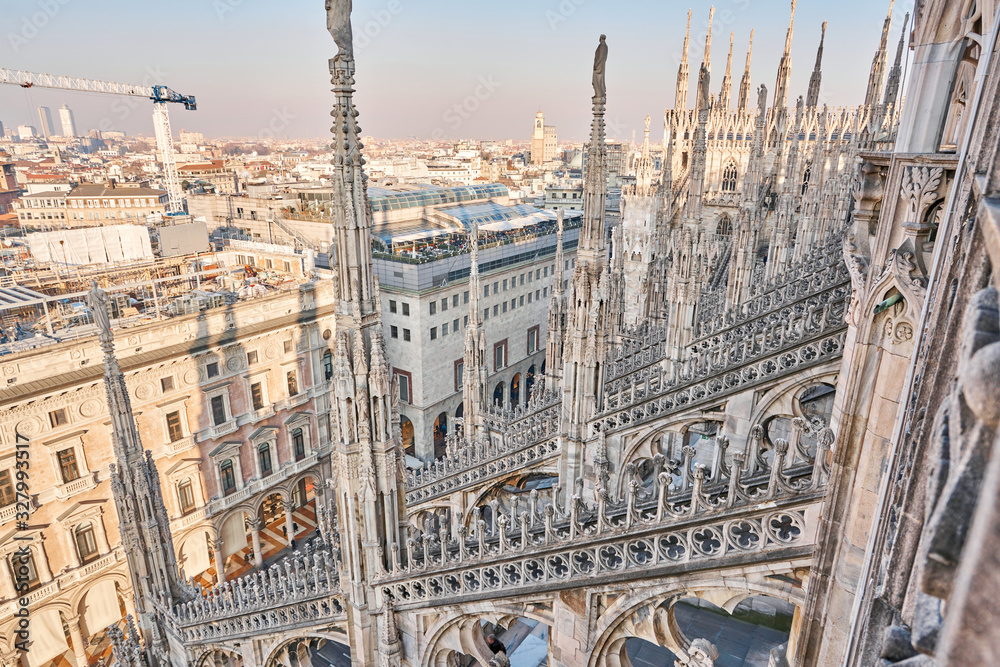 Amazing view of old Gothic spires. Milan Cathedral roof on sunny day, Italy. Milan Cathedral or Duomo di Milano is top tourist attraction of Milan.