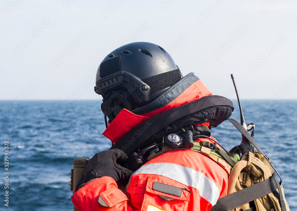 Military soldier from special forces with helmet and vhf radio on ship deck,during operation on sea. Military soldier from special forces with helmet and vhf radio on ship deck,during operation on sea.