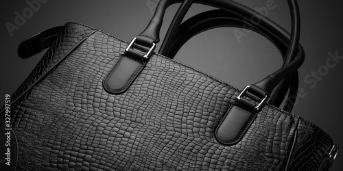 Black fashionable designer women's bag on a dark background