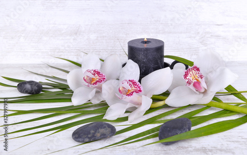 arrangement  with beautiful white orchids  pebbles and candle