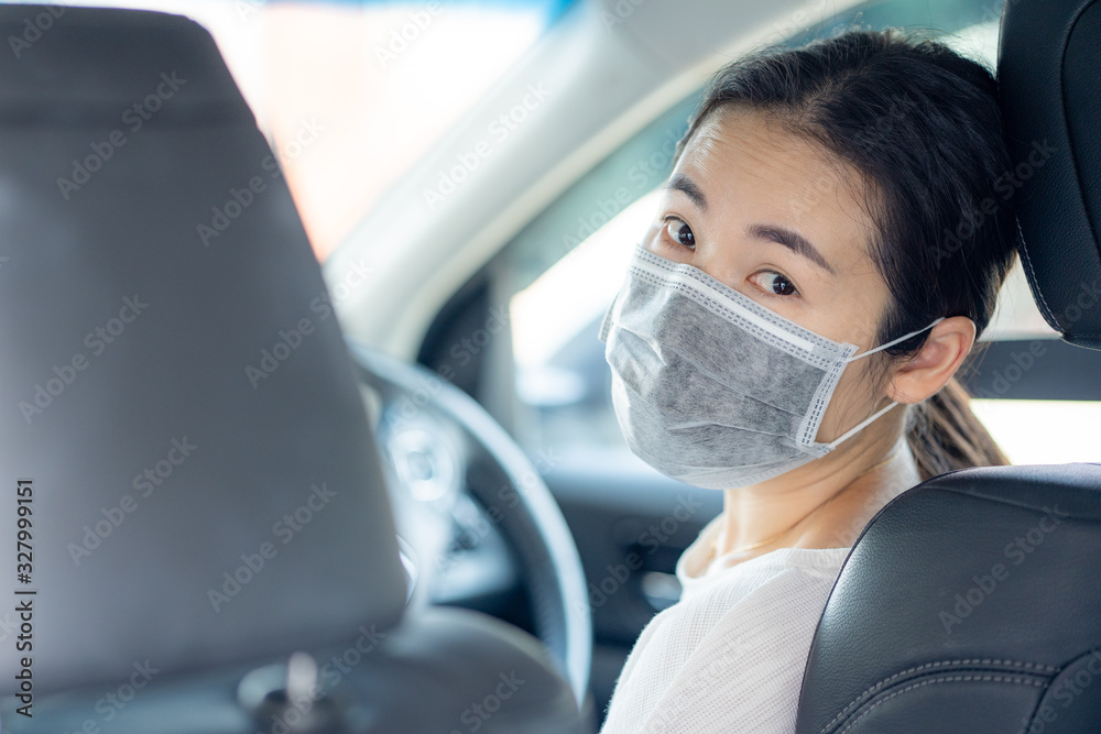 Woman wearing Medical Disposable Face Mask to prevent pollution, flu and convid-19 while driving a car. Woman wearing Medical Disposable Face Mask to prevent pollution, flu and convid-19 while driving a car.