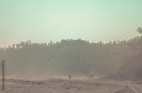 Man going somewhere in a dust storm (ID: 327999370)