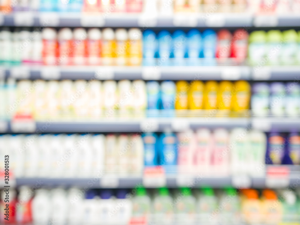 Blurred colorful supermarket products on shelves - Shampoo bottles background with shallow DOF
