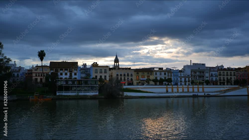 4K Timelapse on the River Guadalquivir bank near the Triana bridge at Blue Hour in Seville, Spain. 4K Timelapse on the River Guadalquivir bank near the Triana bridge at Blue Hour in Seville, Spain.
