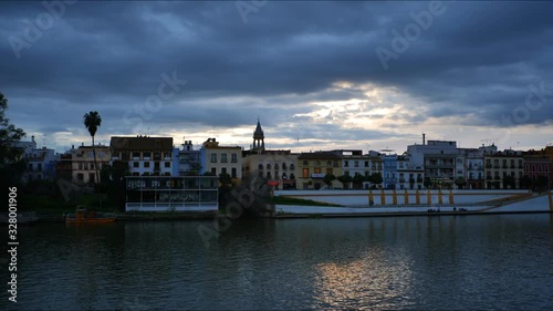 Wallpaper Mural 4K Timelapse on the River Guadalquivir bank near the Triana bridge at Blue Hour in Seville, Spain. Torontodigital.ca