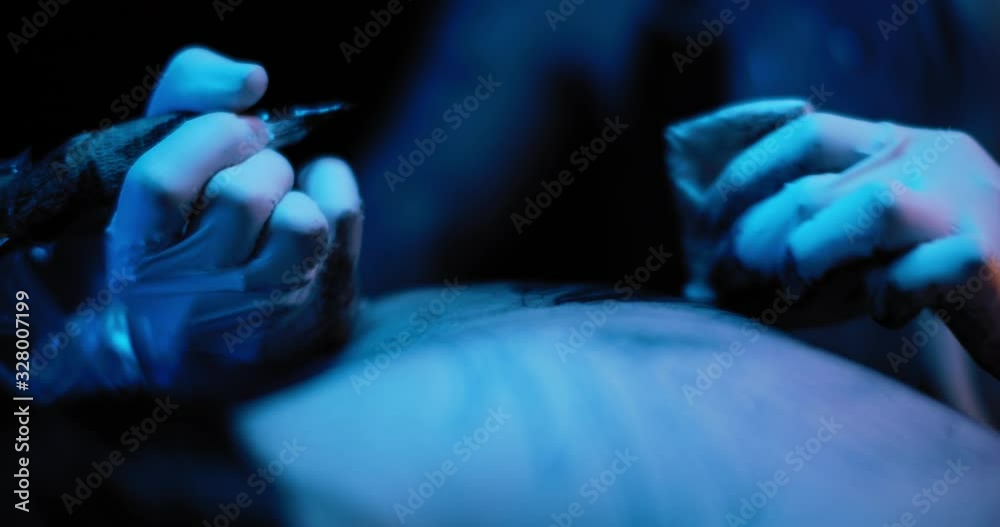 Close up of tattoo artist making a tattoo drawing on a person's body. BMPCC 4K Close up of tattoo artist making a tattoo drawing on a person's body. BMPCC 4K
