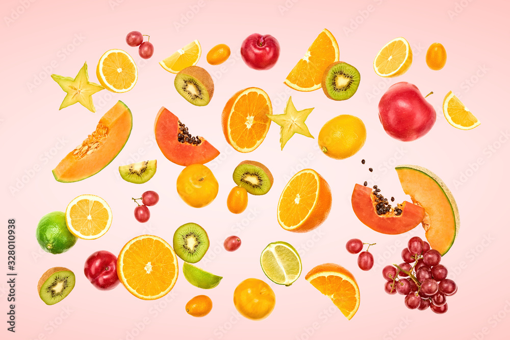 Flying Fruits healthy food summer color background. Papaya, orange, apple, kiwi, melon. Colorful levitation, falling fly fruit creative vitamin concept. Fresh tropical fruit on pink Flying Fruits healthy food summer color background. Papaya, orange, apple, kiwi, melon. Colorful levitation, falling fly fruit creative vitamin concept. Fresh tropical fruit on pink