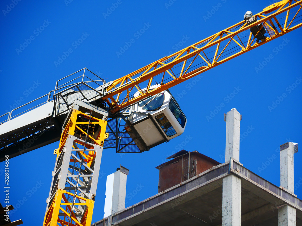 Crane. Self-erection crane over construction site. Crane near bulding. Industrial background