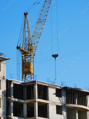 Tower crane and building activity. Construction site background.