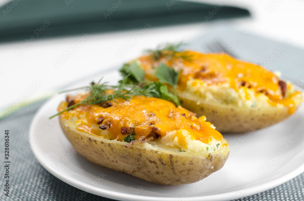 Cooked baked potato with pork belly and cheese.